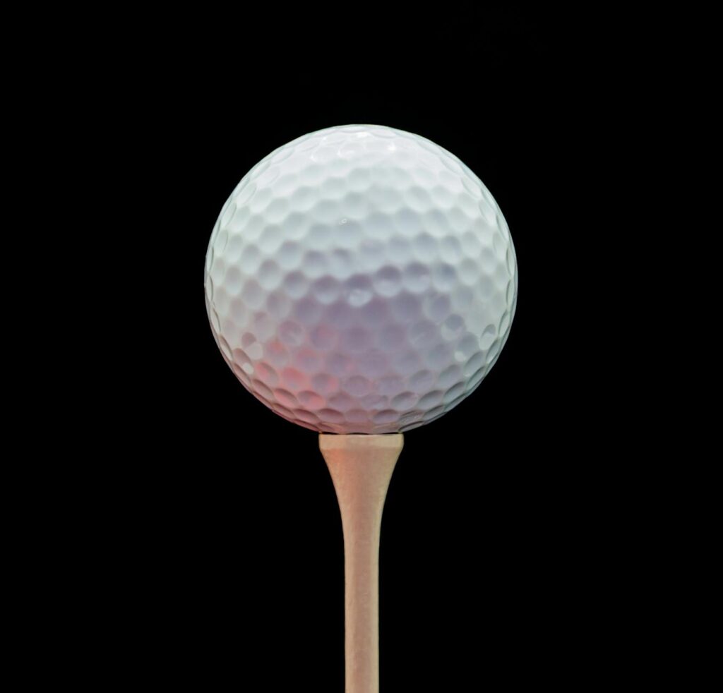 A close-up of a golf ball in the air, illustrating the effect of altitude on ball trajectory. — golfing high altitude we…