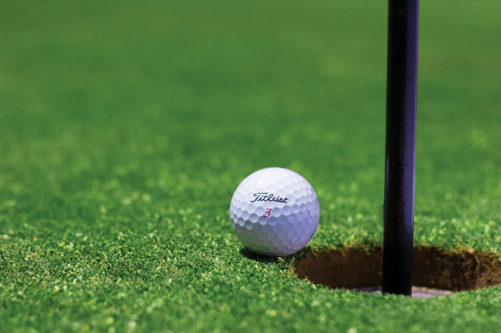 A close-up of a golf ball on a mountain course, highlighting how altitude affects the ball's flight. — golf etiquette hi…