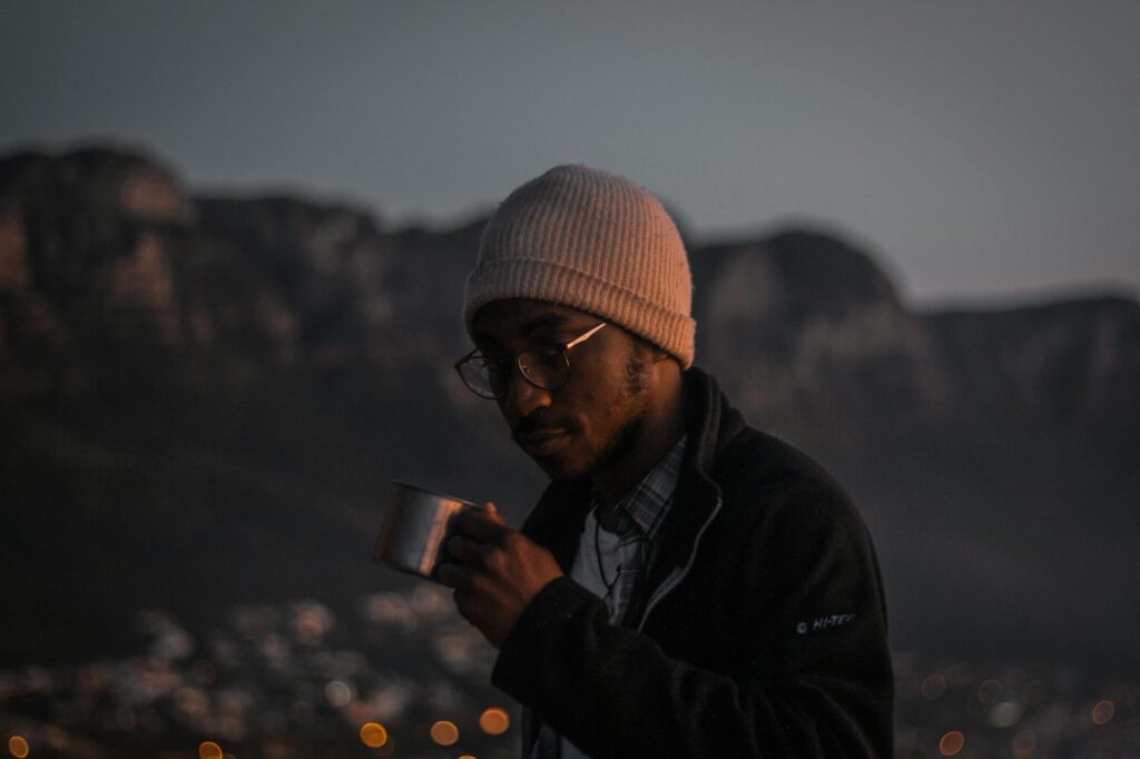 A close-up of a sports drink with a mountain backdrop — hydration high altitude golf