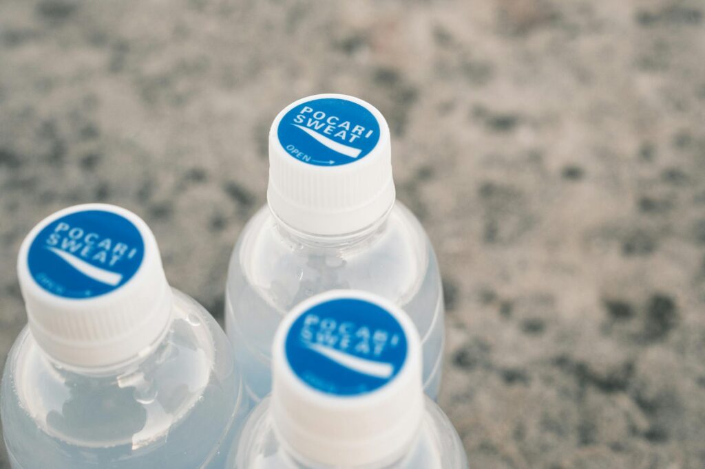 A close-up of a water bottle and electrolyte drink on a golf cart — golf swing hot weather