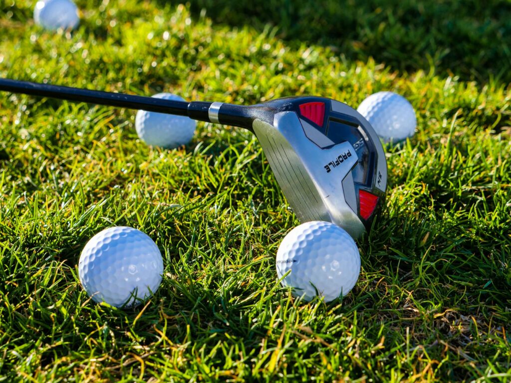 A close-up of golf clubs and balls laid out for a beginner. — beginner golf Dungeness