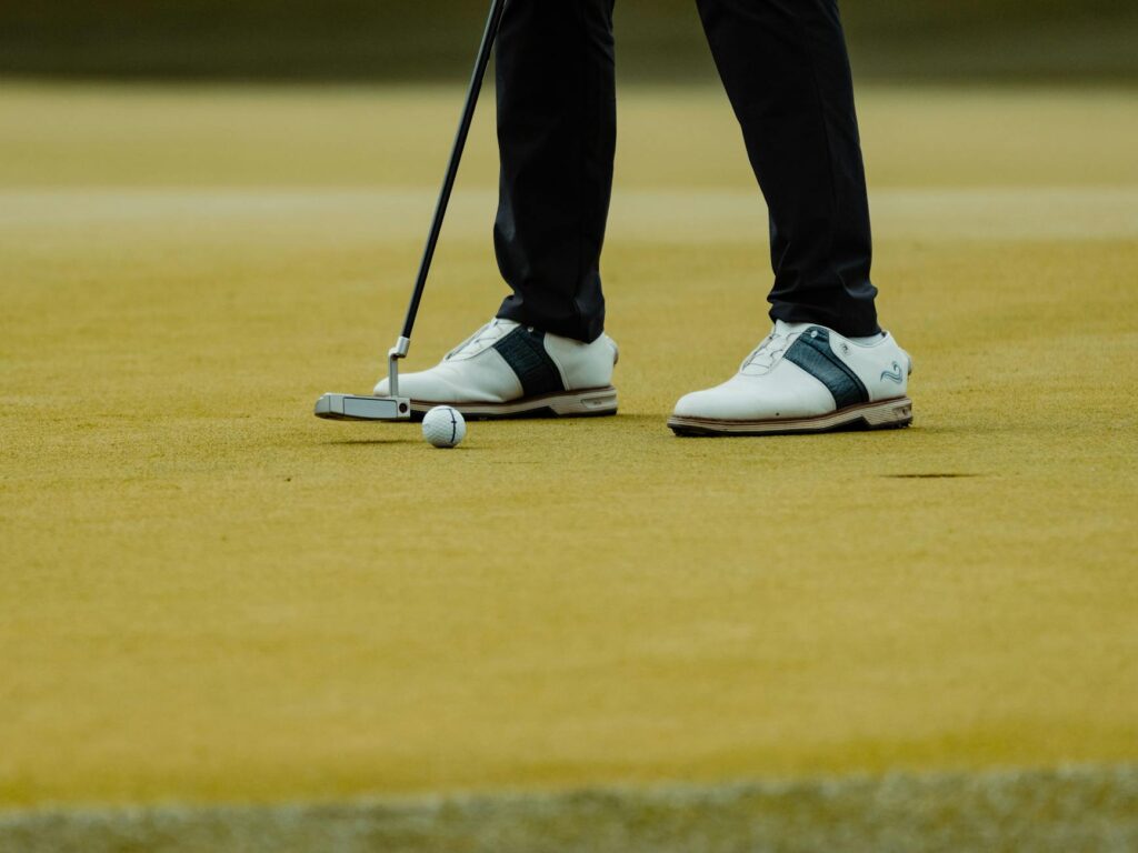A close-up of specialized golf shoes designed for wet conditions. — golf swing in rain
