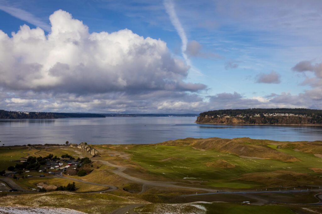 A cozy winter scene of the Dungeness golf course with snow-capped areas. — best time to play golf Dungeness