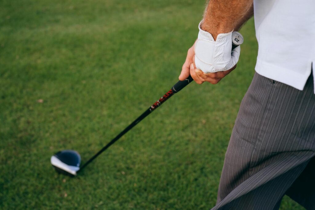 A golfer adjusting their grip and stance on a hot day — golf swing hot weather