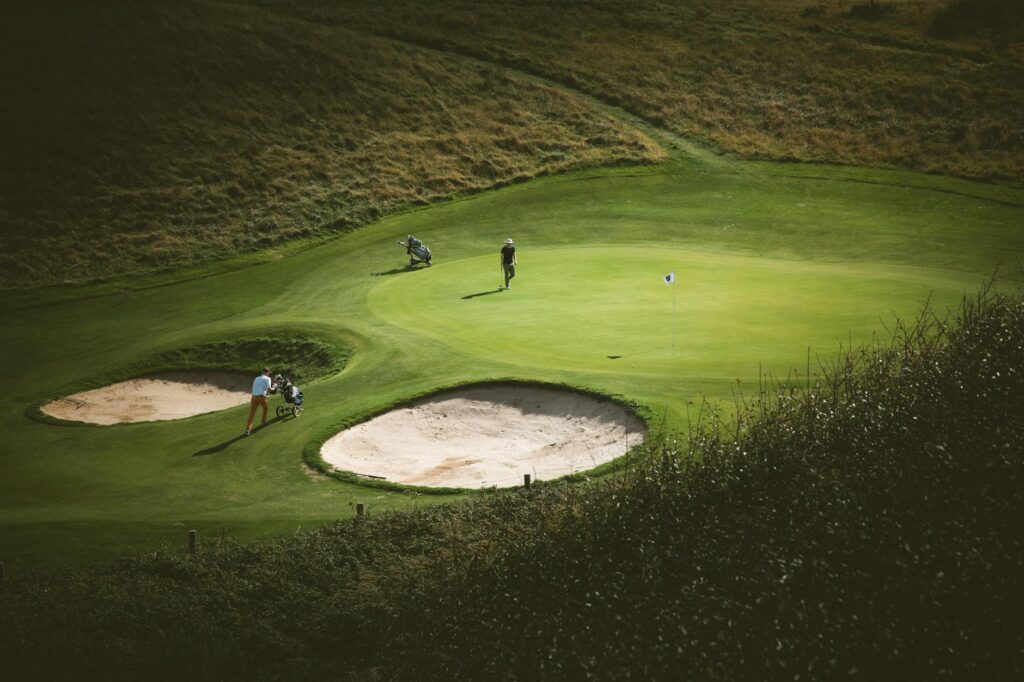 A golfer enjoying a sunny day on the Dungeness golf course in spring. — best time to play golf Dungeness
