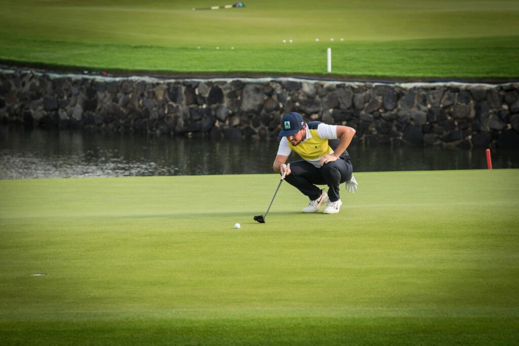 A golfer navigating one of the challenging water hazards at Dungeness. — Dungeness Golf features