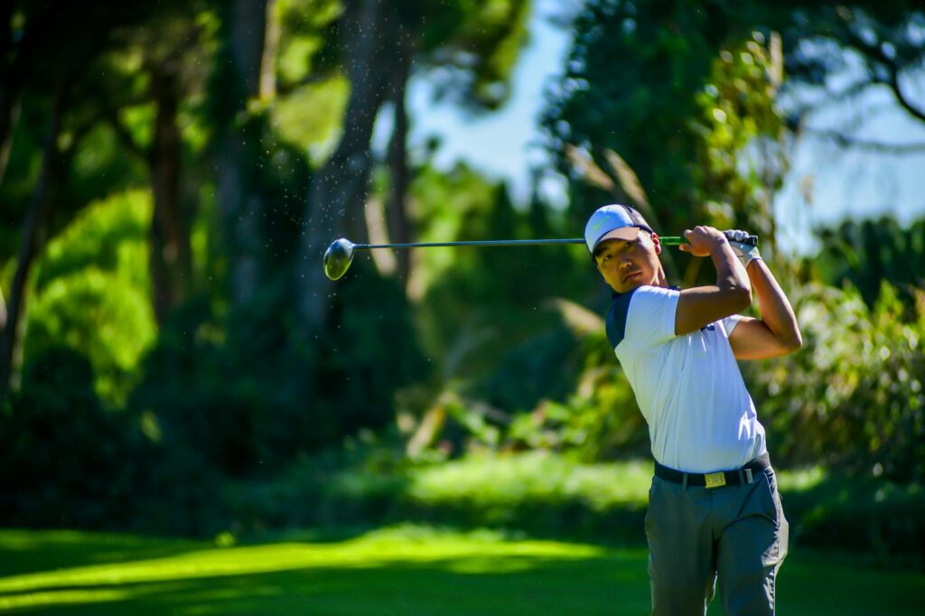 A golfer on a sunny course demonstrating perfect swing technique under clear skies. — best golf courses weather conditions