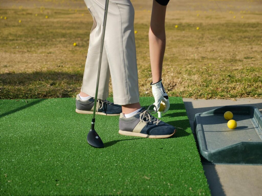 A golfer practicing their stance adjustments on a high altitude driving range. — golf swing adjustment high altitude