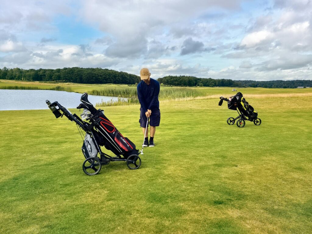 A golfer using a waterproof golf bag in a rainy Dungeness setting — golf equipment Dungeness
