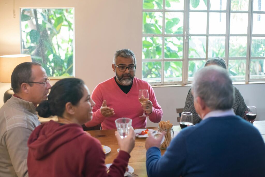 A group of friends discussing their golfing itinerary over dinner in Dungeness. — golf trip to Dungeness