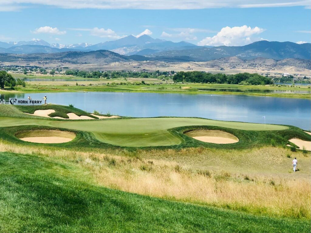 A scenic view of a high altitude golf course with mountains in the background. — golf scores high altitude sea level