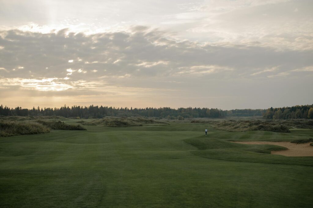 A scenic view of one of the top Dungeness golf courses during sunset.