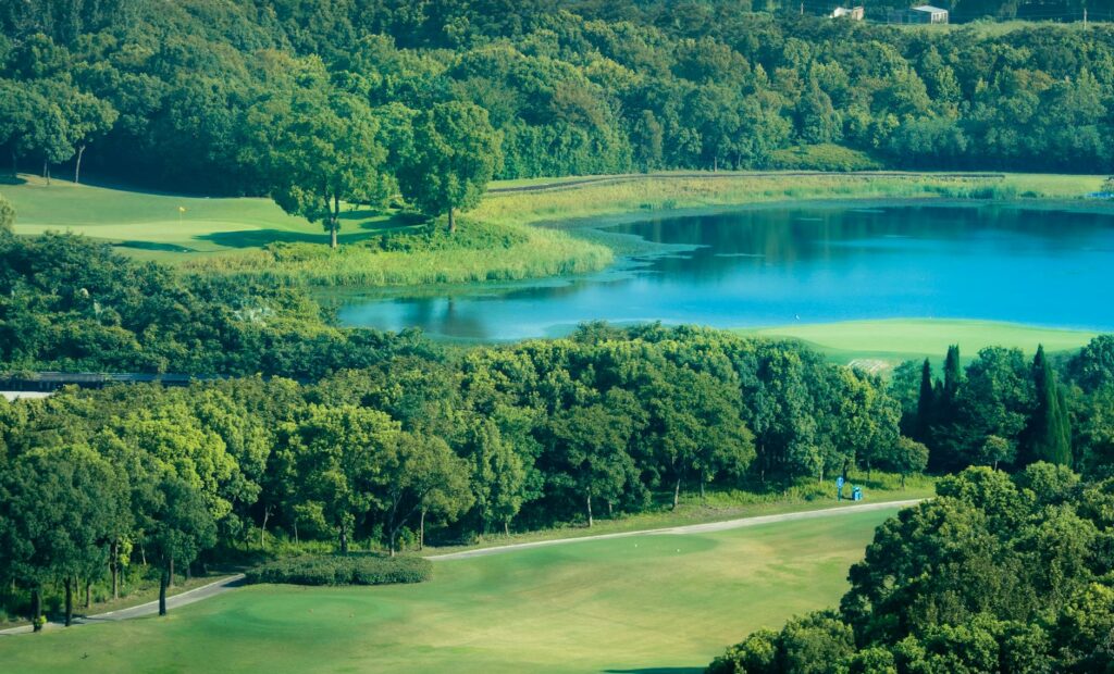 A serene lake view from Mountaintop Golf and Lake Club surrounded by trees — best high altitude golf courses USA