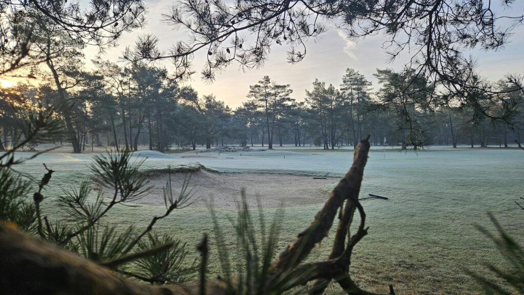 A winter landscape of a Dungeness golf course covered in light frost, showing the unique winter golfing experience. — go…