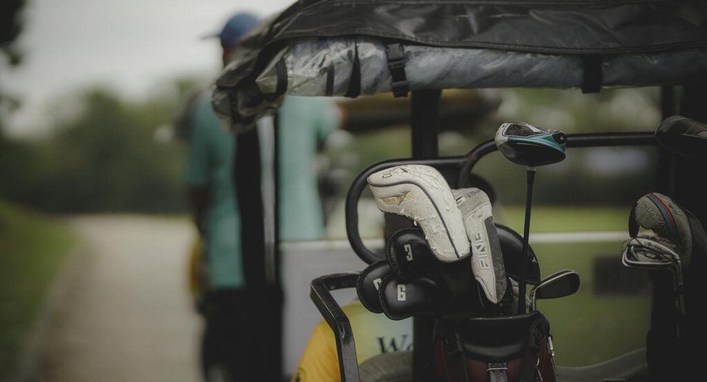 An organized golf bag with rain cover on a wet course. — golf gear wet weather