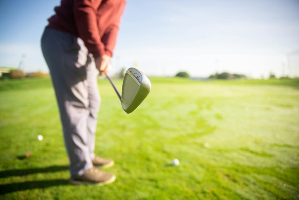 Close-up of a golfer putting on the green at a Dungeness golf course. — golf courses in Dungeness