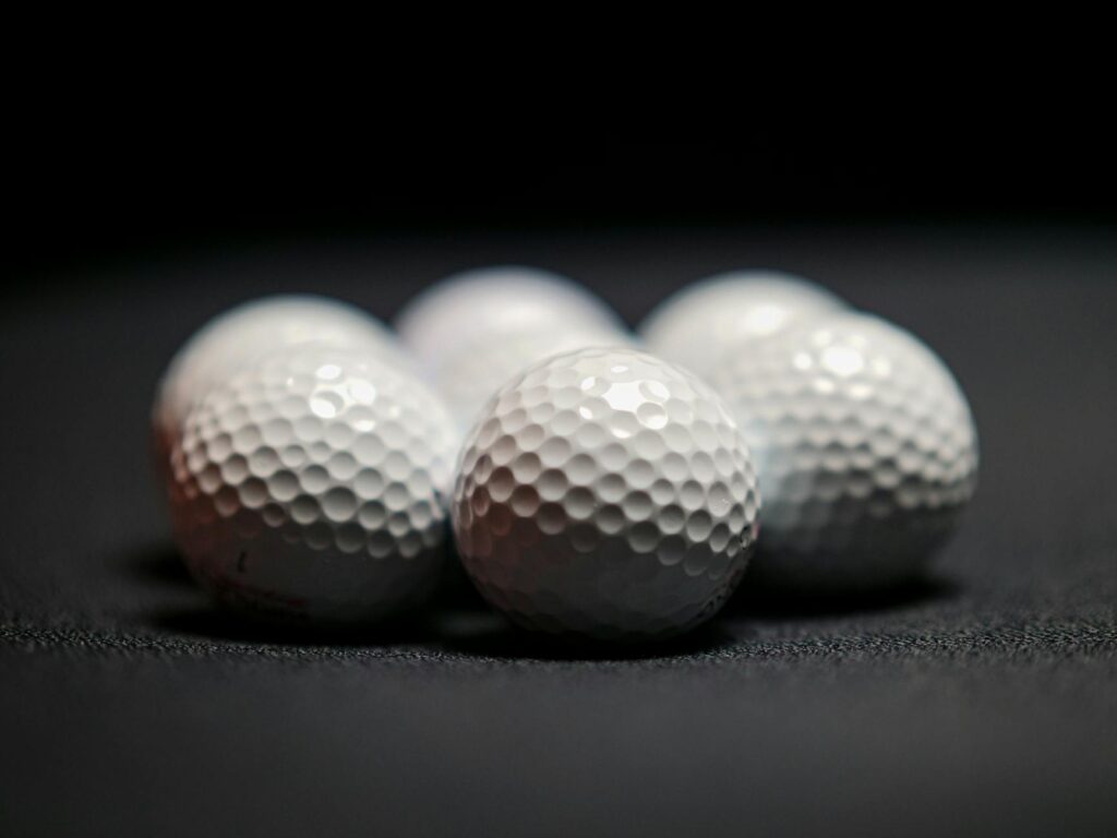 Close-up of different golf balls showcasing their textures and designs. — golf balls for high altitude