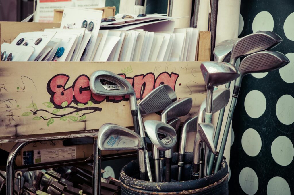 Close-up of golf clubs displayed for sale, highlighting different brands. — Dungeness golf equipment shops
