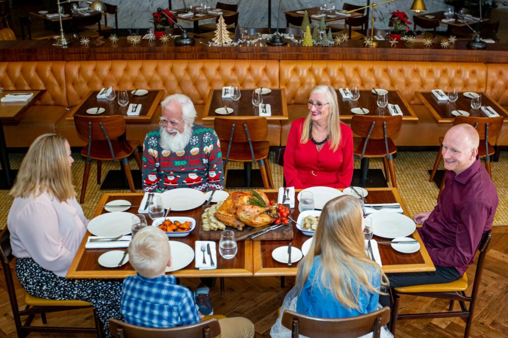 The clubhouse dining area at Dungeness with families enjoying meals. — family golf Dungeness