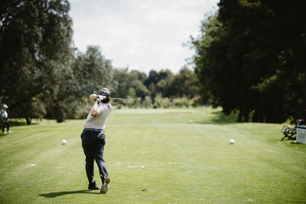 A Dungeness golf pro demonstrating proper swing mechanics on the course. — improve golf swing Dungeness