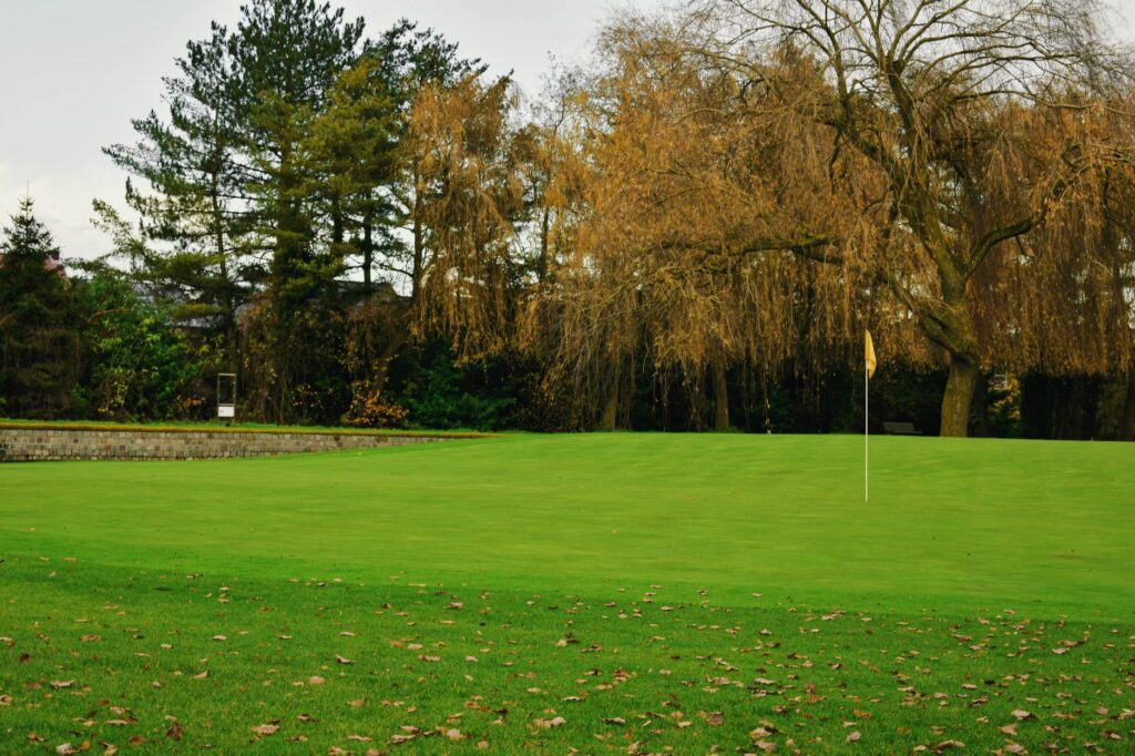 A beautiful autumn landscape showcasing fall foliage on the golf course. — best time to golf Dungeness
