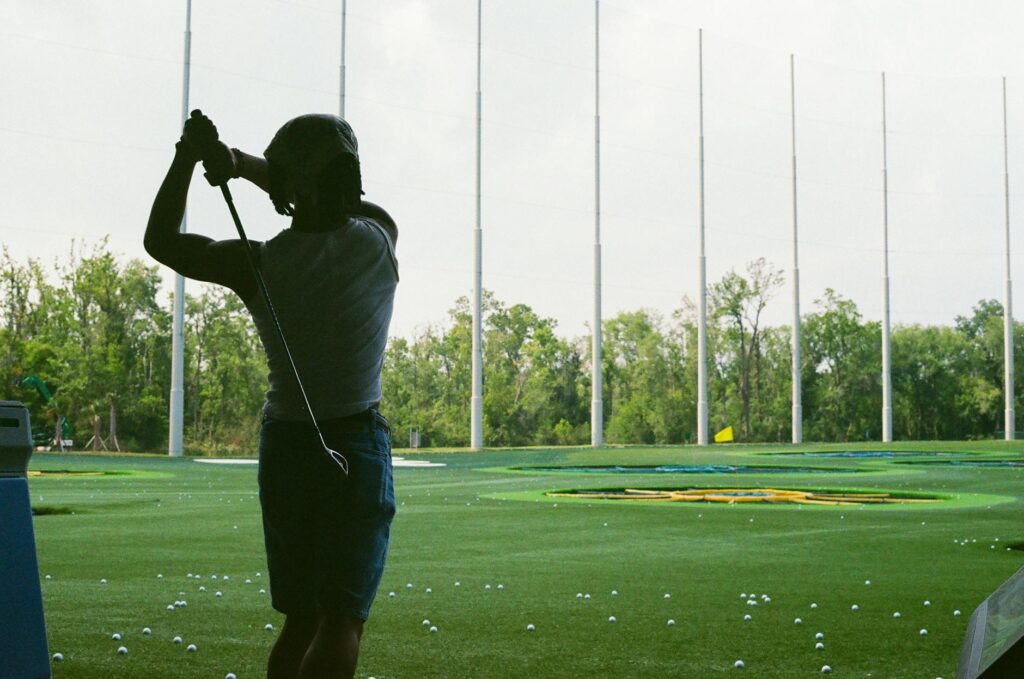 A beginner golfer practicing their swing at a driving range — beginner golf Dungeness