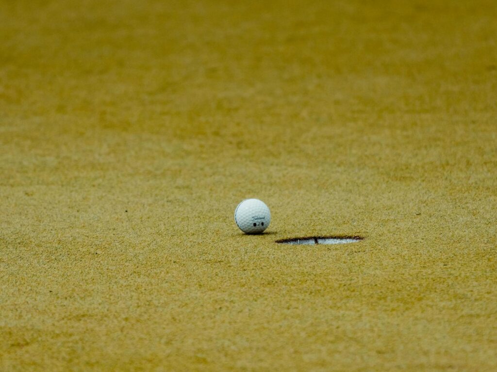 A close-up of a golf ball on the green at San Francisco Golf Club. — best public golf courses California
