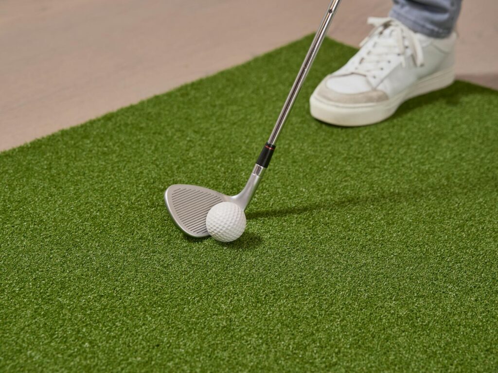 A close-up of a putting green at Dungeness with a golfer lining up a shot. — Dungeness golf tips