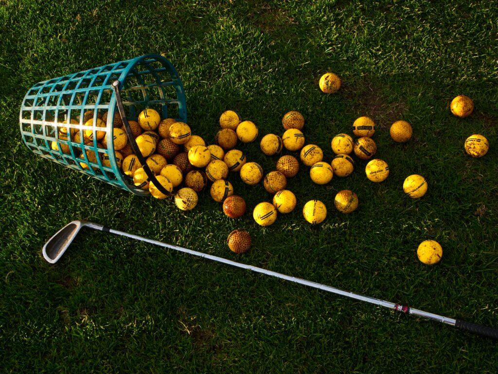 A close-up of golf balls and clubs used in early Dungeness golf. — history of golf Dungeness