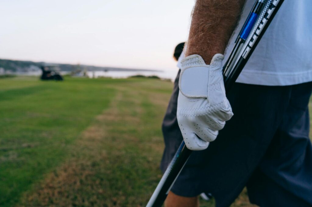 A close-up of winter golf gear, including gloves and hats — winter golf courses