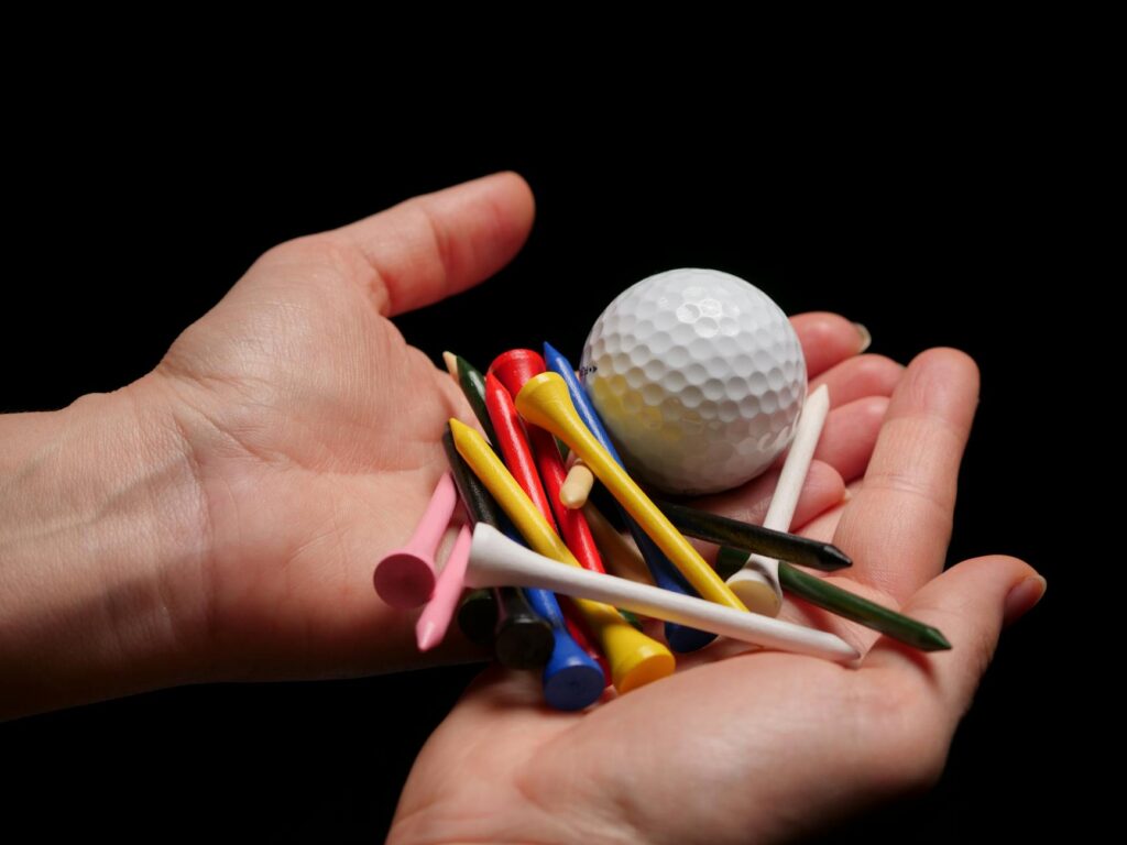 A collection of must-have golf balls and tees for local play. — golf gear Dungeness