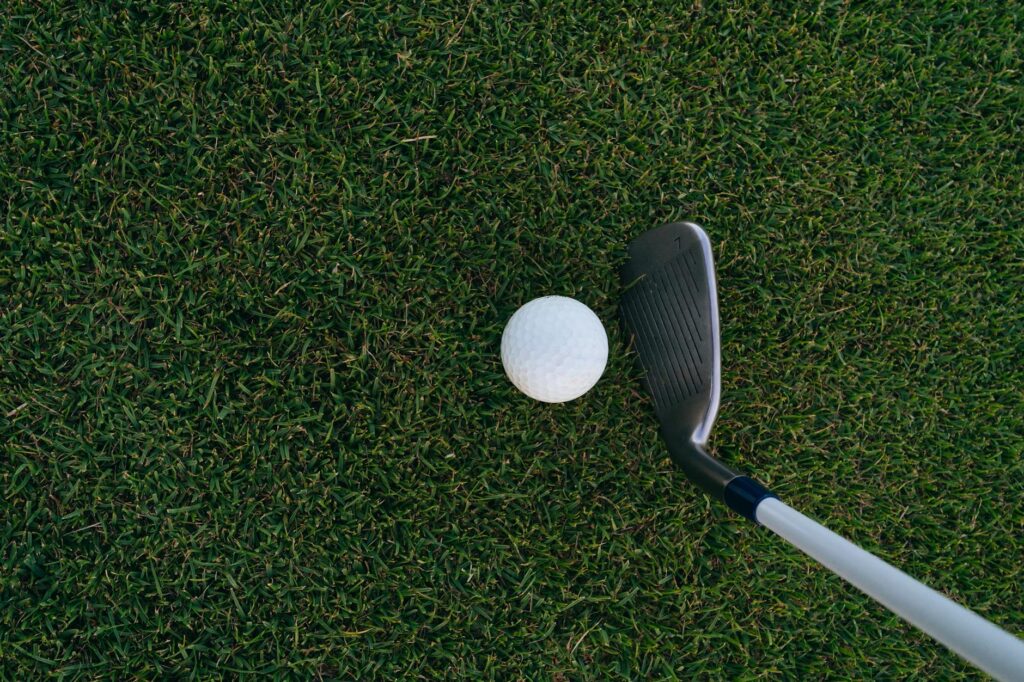 A detailed view of a golf club and ball on a Dungeness course. — golf trip Dungeness