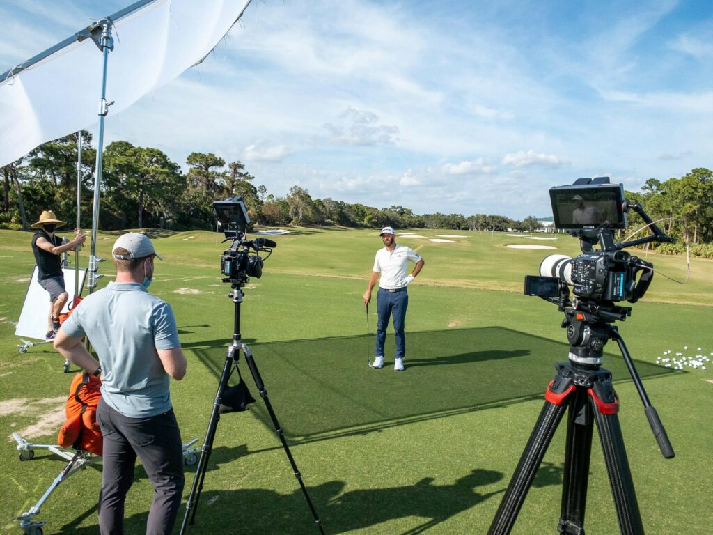 A golfer analyzing their swing with a video camera. — improve golf swing