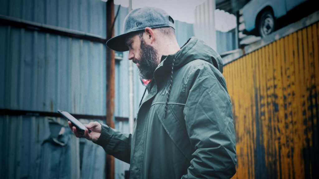 A golfer checking the weather forecast on a mobile device before playing. — best times to play golf Dungeness