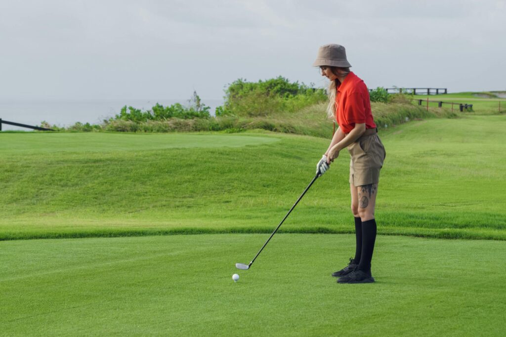 A golfer dressed appropriately for the weather in Dungeness. — golf gear Dungeness