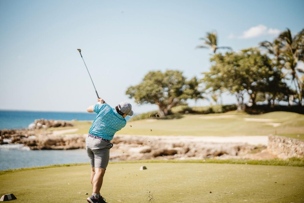 A golfer enjoying a scenic hole at Wailea Golf Club with palm trees and ocean — golf courses with ocean views