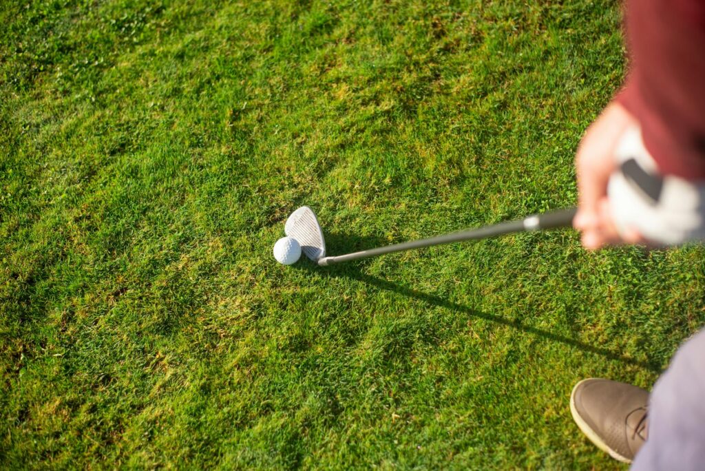 A golfer practicing swing drills aimed at slice correction — fix golf slice
