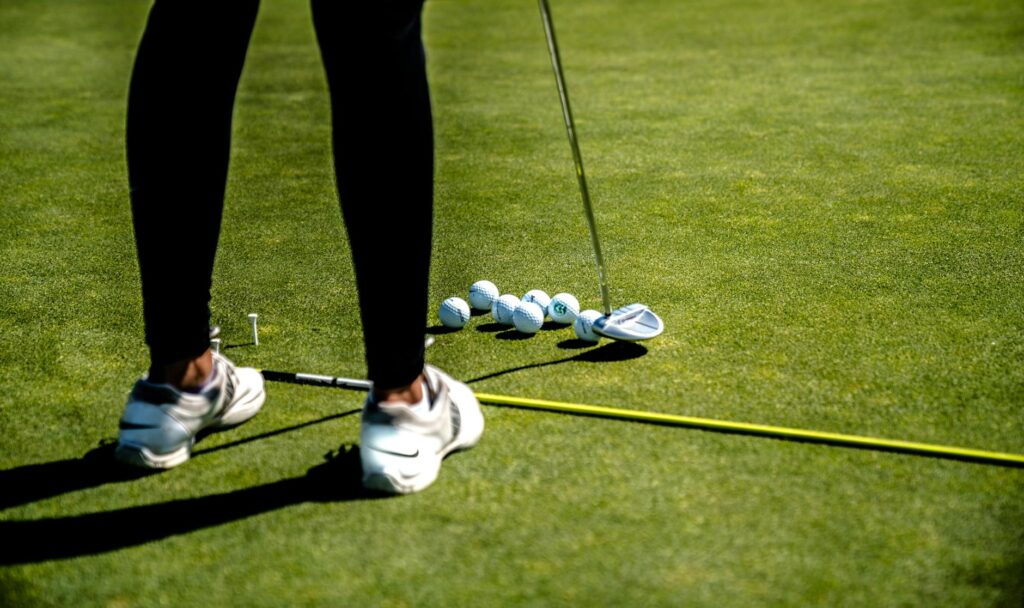A golfer practicing their putting on the green, focusing on technique. — lower golf score tips
