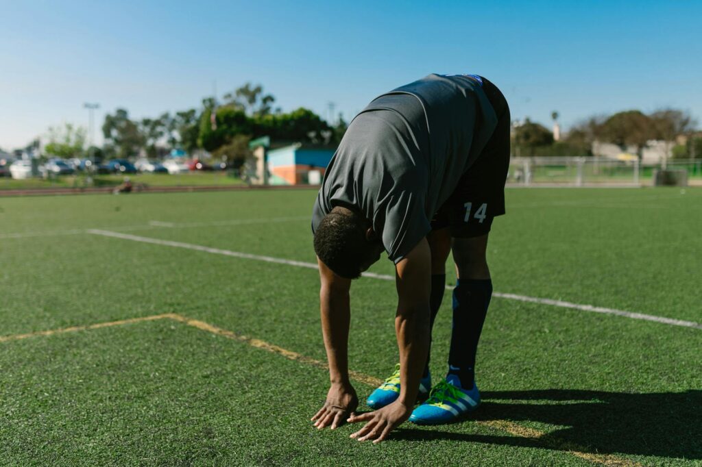 A golfer stretching before a game to improve flexibility — Dungeness Golf tips