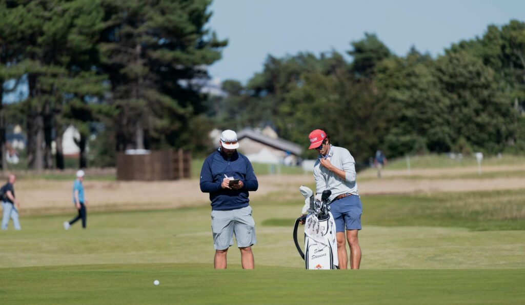 A golfer using a GPS device on a Dungeness course. — golf gear Dungeness