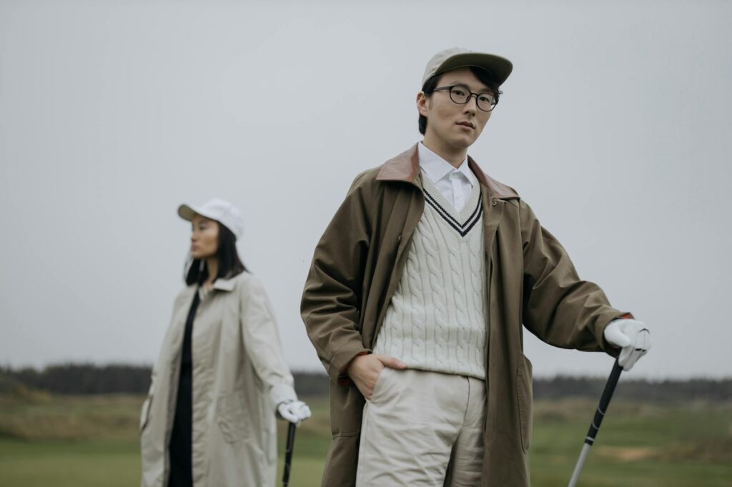 A golfer wearing appropriate clothing for Dungeness' weather conditions on the course. — golf trip packing list Dungeness