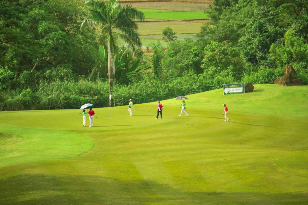 A group of friends enjoying a round of golf at a scenic international course. — must-play golf courses
