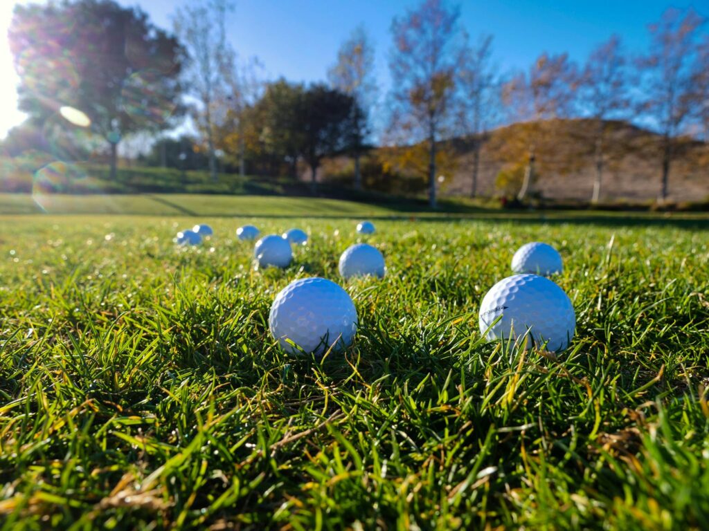 A group of friends enjoying a round of golf on a sunny afternoon. — best times to play golf Dungeness