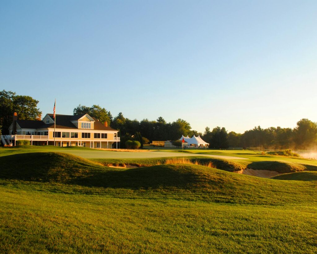 A serene lakeside view of a top golf course in the US during sunrise. — must-play golf courses