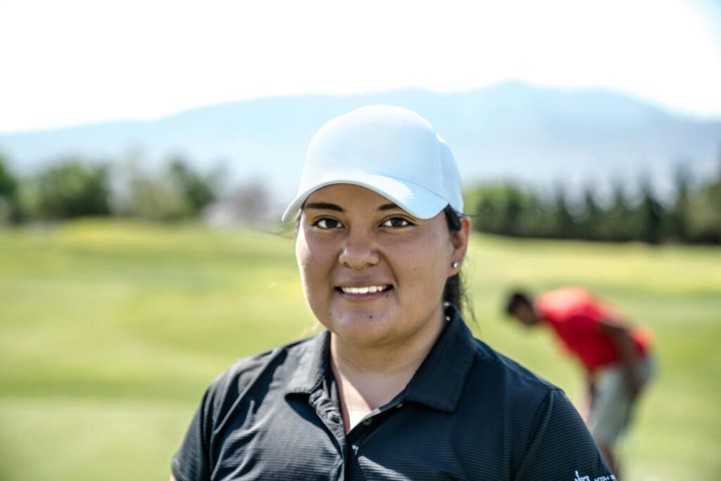 A smiling new golfer enjoying their first round on the course. — best golf courses for beginners