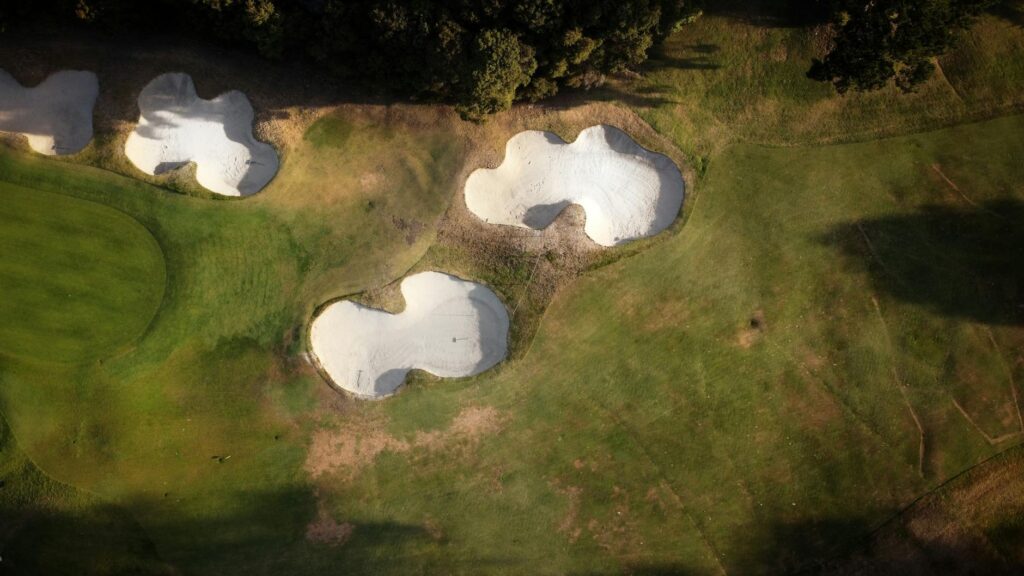 A stunning aerial view of Augusta National Golf Club showcasing its pristine greens. — championship golf courses