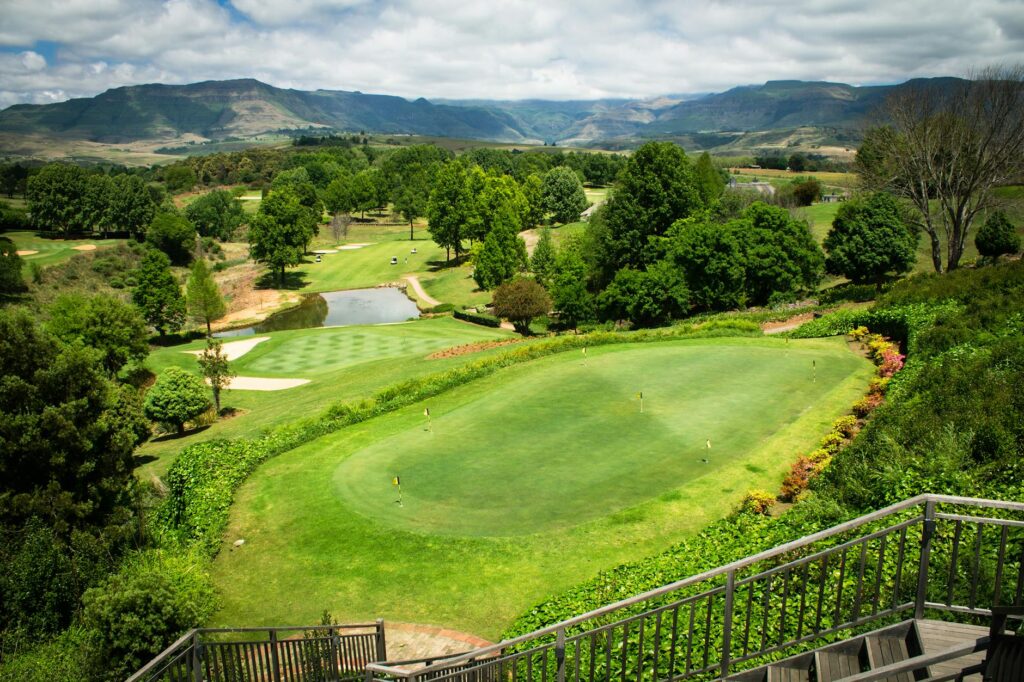 Aerial view of a stunning golf course in Cape Town with Table Mountain in the background. — best golf courses in South A…
