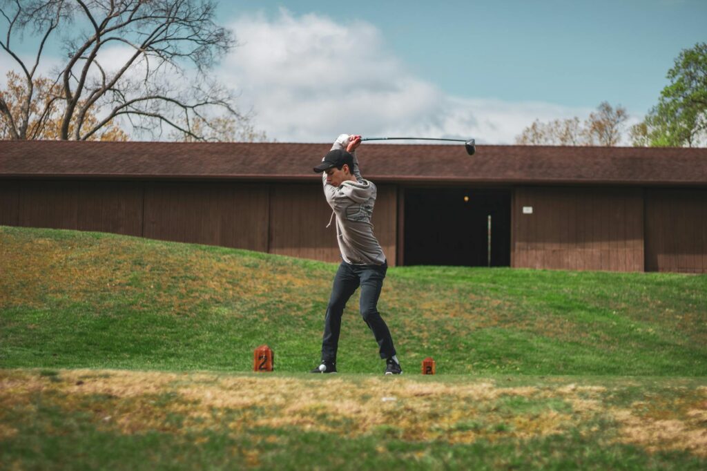 An action shot of a golfer practicing their swing on a Dungeness course. — golf swing tips Dungeness