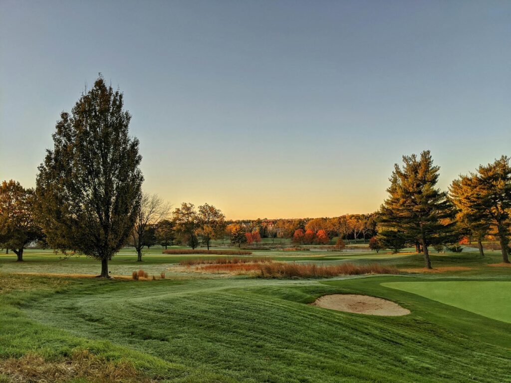 An autumn landscape of Dungeness golf course, featuring colorful fall foliage lining the fairways. — best time to visit …