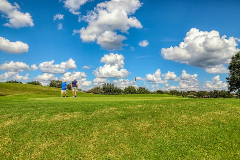 Golfers enjoying a round of golf at a sunny Florida course in winter — winter golf courses
